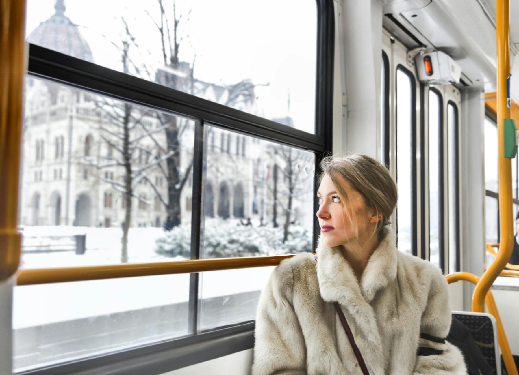 cam young woman in warm clothes in public transport