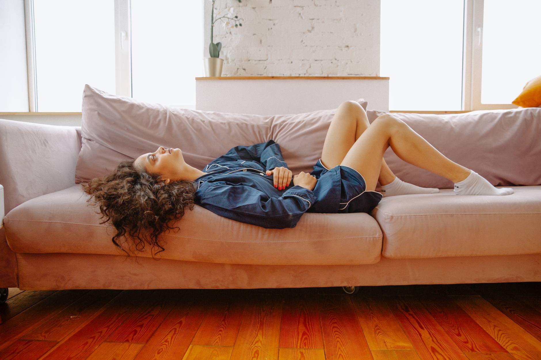 woman lying on couch