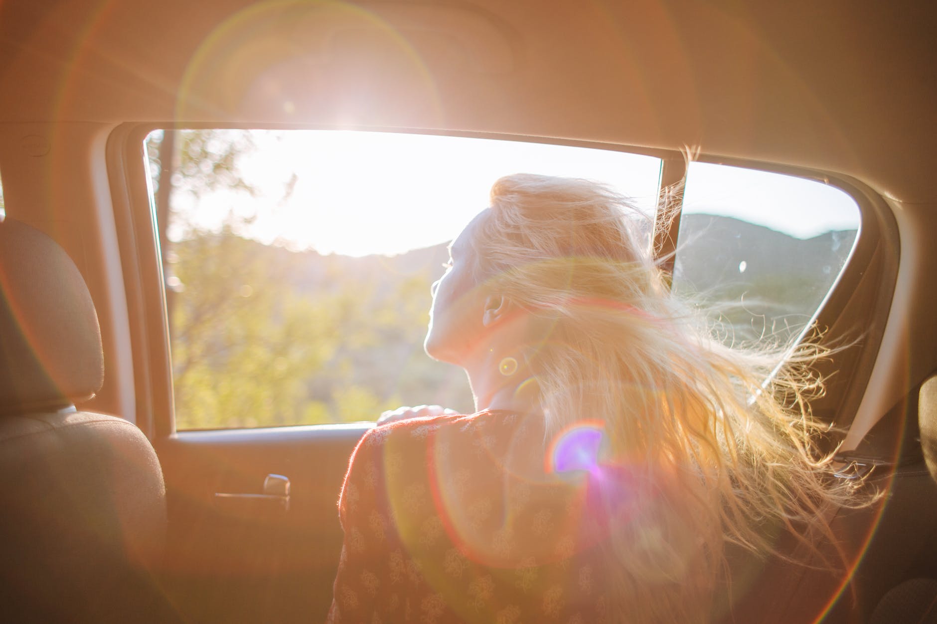 woman looking out of car window