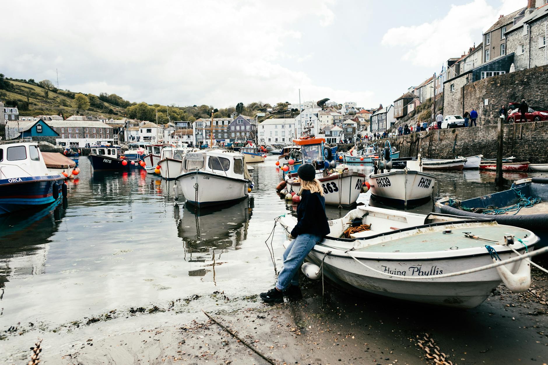 a woman sitting on white boat