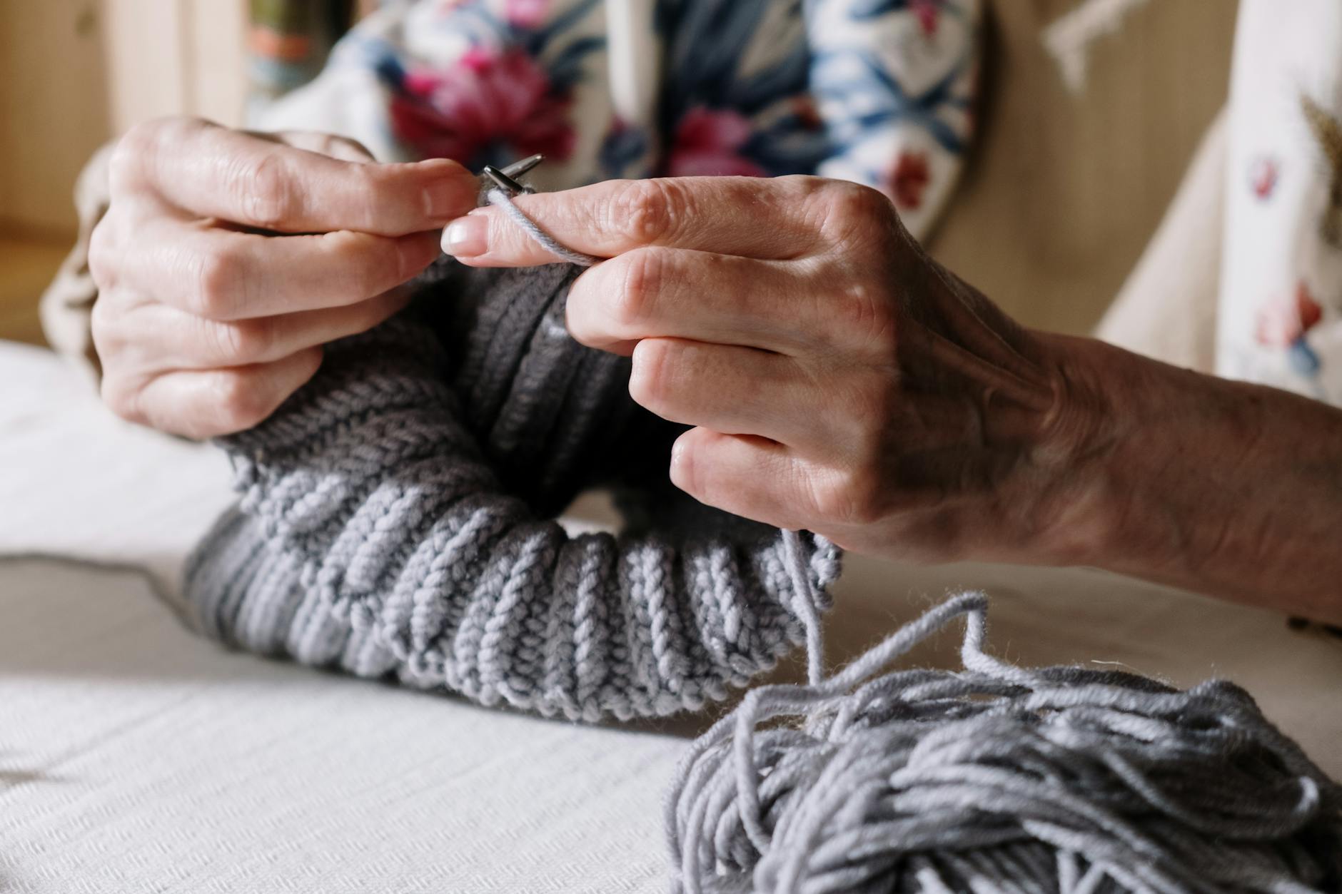 person holding knitting needles