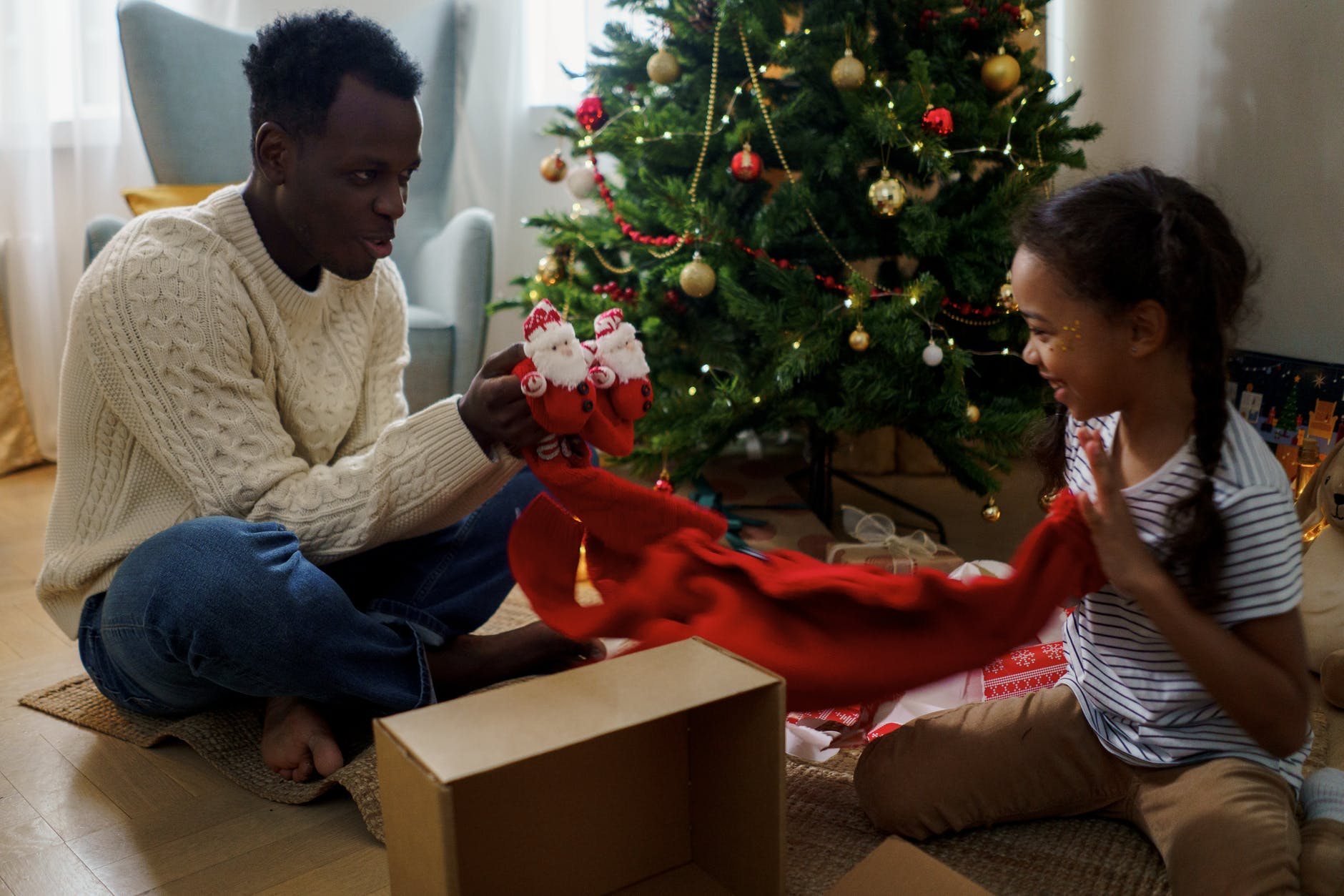 dad and daughter unboxing a christmas present