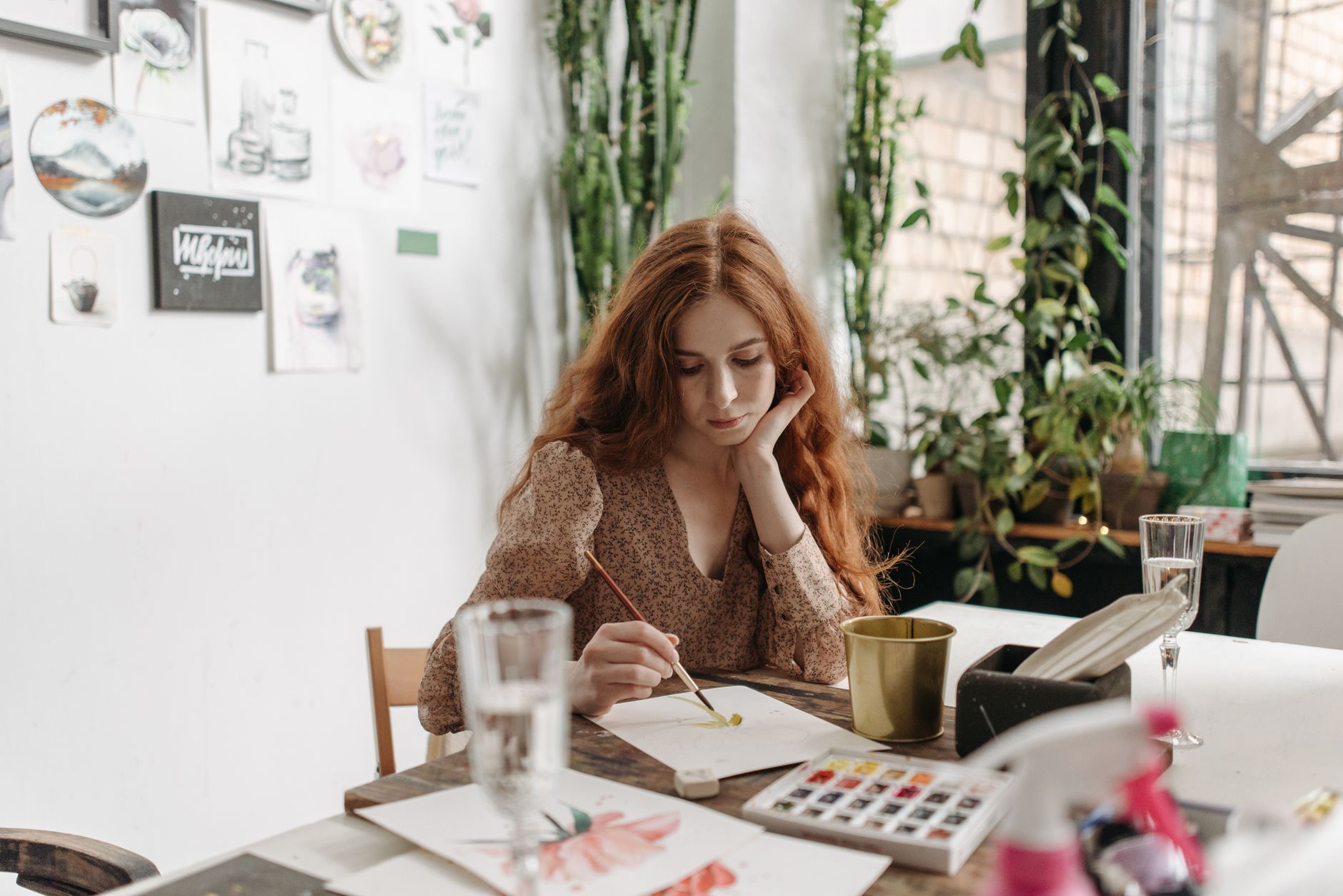 a woman painting on a paper