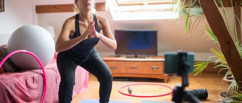 a woman doing exercise while recording herself